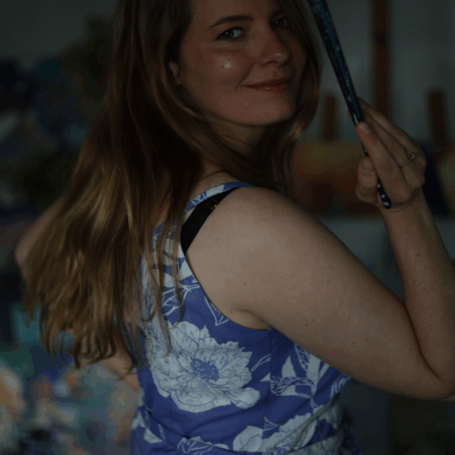 Karolina Howorko working in her studio on a large abstract canvas.
